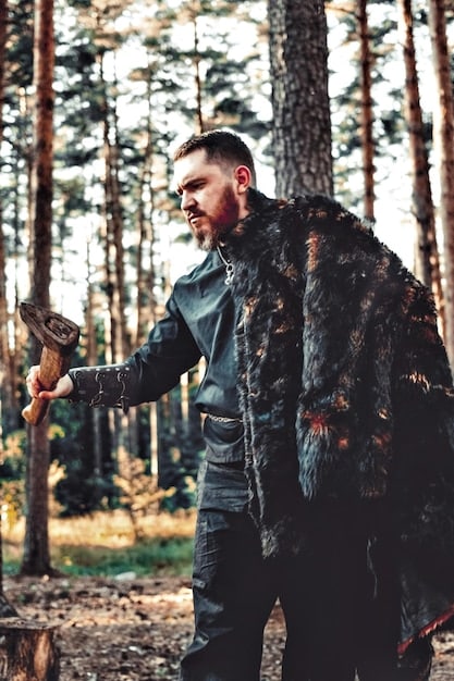 Liam Hemsworth in costume as Geralt of Rivia, standing in a snowy forest, sword drawn, looking determined but also contemplative. The image portrays him in action, yet with a hint of vulnerability.