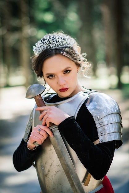 A close-up shot of Queen Calanthe of Cintra, in full battle armor, leading her troops. Her face is determined and fierce.