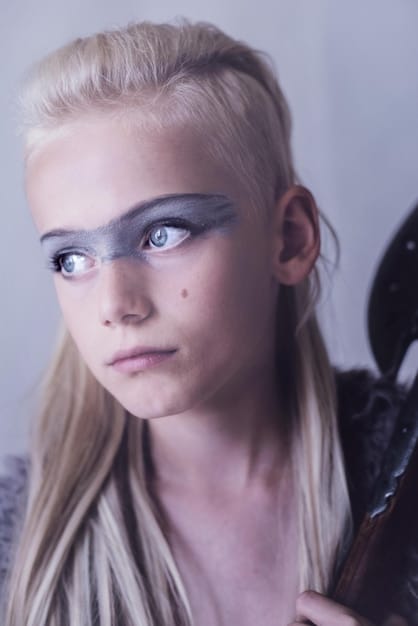 A close-up shot of Freya Allan as Ciri, looking determined and focused. Her expression reflects her growing strength and resilience as she trains to become a Witcher. The lighting highlights her intense gaze, emphasizing her inner strength.