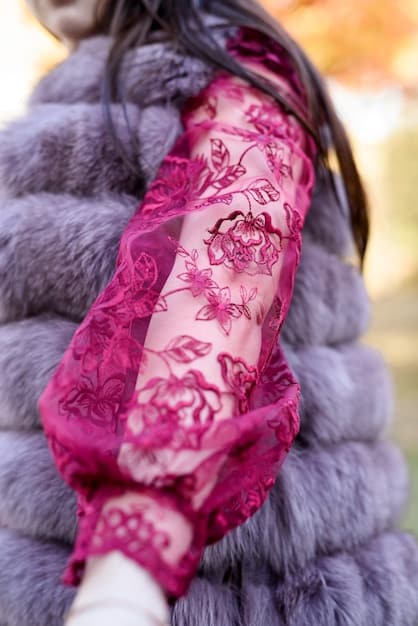 A close-up of Yennefer of Vengerberg in one of her elaborate gowns, highlighting the intricate details of the embroidery and fabric.