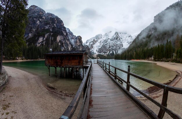 Lago di Fusine in Italy, showing the crystal clear lake and surrounding alpine mountains used in The Witcher's landscape shots.