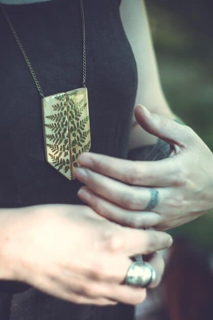 A poignant image of Ciri holding the Swallow pendant, a symbol of her Witcher heritage and her bond with Geralt. The pendant gleams softly, highlighting its significance as a family heirloom and a reminder of her past.