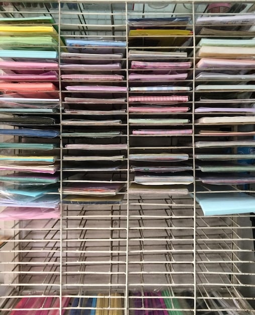 A well-organized comic book collection, showing comics neatly arranged in mylar bags with acid-free boards, inside sturdy, labeled storage boxes on shelves.