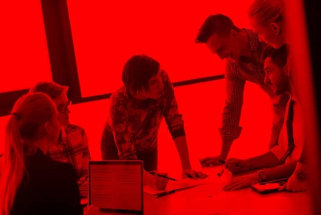 An image showcasing CD Projekt Red employees collaborating in a creative workspace, highlighting their team-oriented culture.