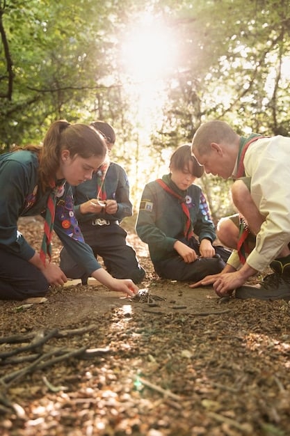 A group of conservationists in Poland working in a forest, planting trees and setting up wildlife monitoring equipment. The scene should highlight the hands-on work being done to protect the environment.