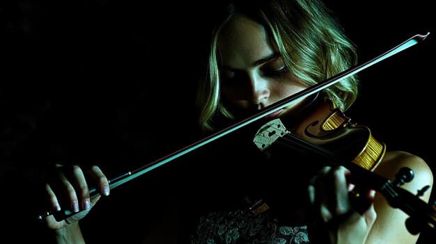 Close-up of a violinist passionately playing during The Witcher music concert, with dynamic lighting creating a dramatic effect.