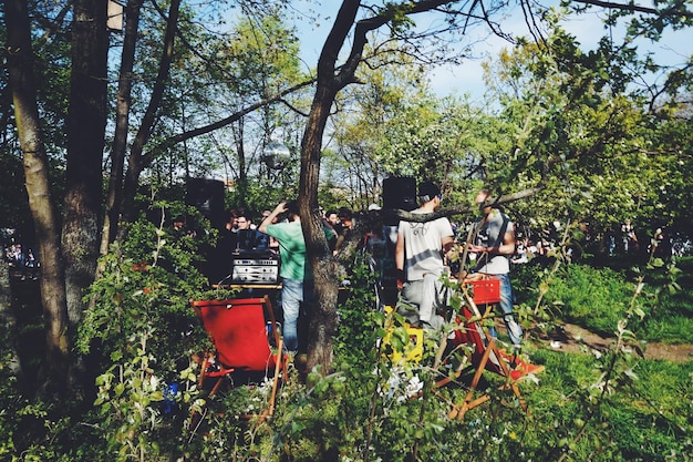 A heartwarming image of volunteers planting trees in a deforested area of Poland. The volunteers should be diverse and engaged in the activity, representing the collective effort towards environmental restoration.