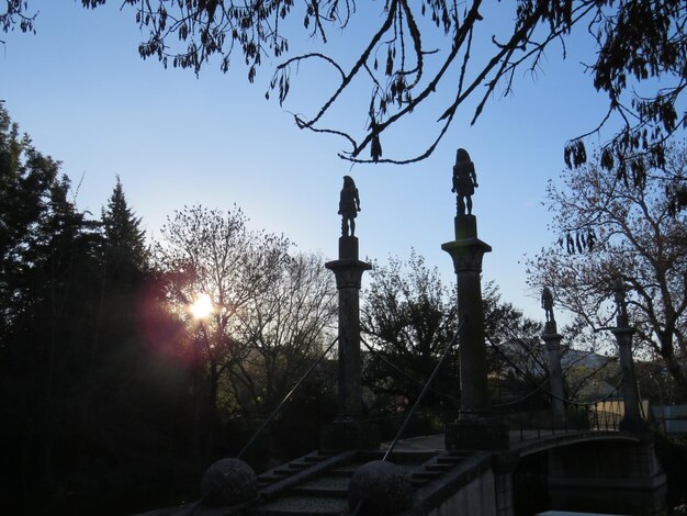 A serene image of a cemetery at twilight, with soft lighting casting long shadows among the tombstones. The scene is peaceful and contemplative, suggesting a connection to the past and the possibility of spirits lingering in the present. The composition evokes a sense of respect and reverence for those who have passed on.