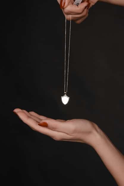 A close-up shot of a crystal pendulum swinging over a detailed chart, with a hand gently holding the chain, set against a backdrop of softly blurred crystals and candles.