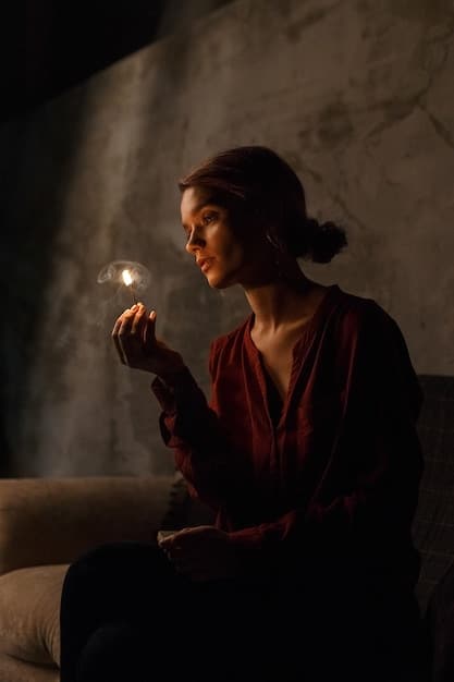 A person meditating while holding a crystal in their hands, with a serene and focused expression. The background is a softly lit room with candles and other crystals arranged around them.