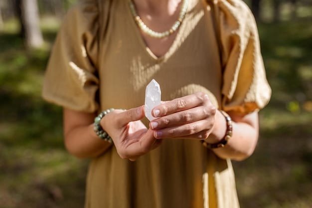 A person holding a smooth, polished rose quartz crystal in their hand, focusing on the detail of the crystal's pink hue and clarity. The background is softly blurred, suggesting a peaceful and natural setting, like a garden or park.
