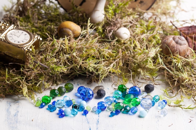 A bird's-eye view of a collection of crystals arranged on a wooden surface. The crystals include amethyst, rose quartz, blue lace agate, and lepidolite. The arrangement is neat, and the crystals vary in size and shape, showing their natural diversity.