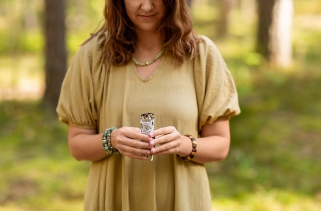 A person holding a clear quartz crystal in their hands, meditating outdoors with a serene expression. Sunlight is filtering through the trees, creating a peaceful and natural setting, symbolizing the connection between crystal healing and nature.