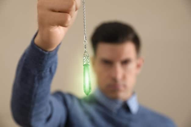 A close-up shot of a crystal wand being used to direct energy towards a person lying down during a crystal healing session. Focus on the wand and the healer's hands, with the client blurred in the background. The setting is a softly lit, calm space.