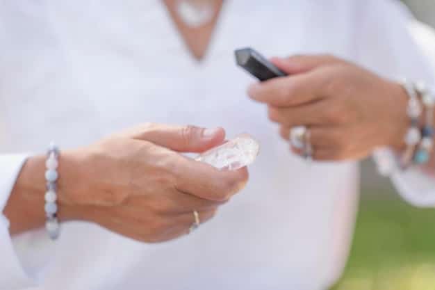 A crystal healing practitioner using a clear quartz wand to cleanse a client's aura, directing the wand around the client's body in a sweeping motion. The practitioner is focused and wearing a white robe, while the client is relaxed and seated.
