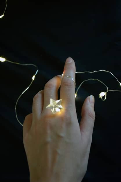 Close-up shot of a person's hands holding a selenite wand, with a soft, ethereal glow emanating from the crystal. The background is blurred, creating a sense of focus and tranquility.