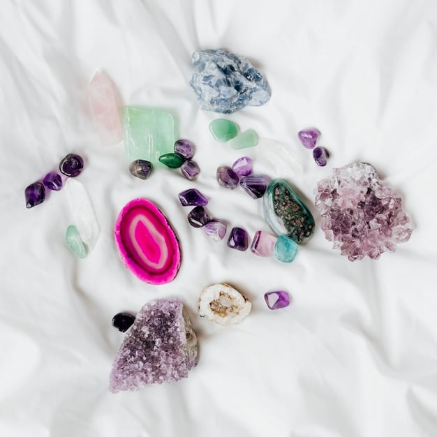 A variety of crystals displayed on a white cloth, including rose quartz, amethyst, clear quartz, and citrine. The crystals are arranged in a visually appealing manner, showcasing their different shapes, sizes, and colors.