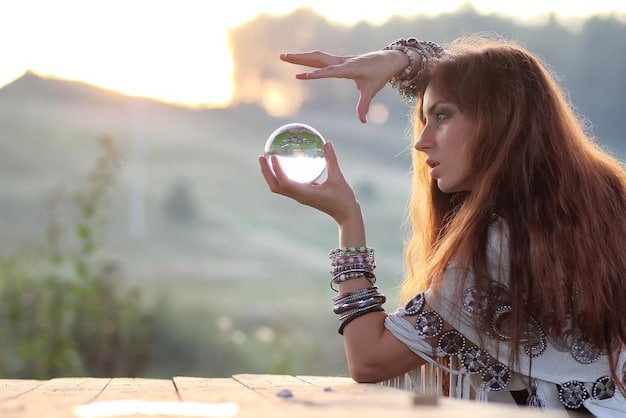A person holding a clear quartz crystal point towards the sky while meditating on a hilltop during sunset. The image evokes a sense of serenity, connection with nature, and spiritual practice. Light shines through crystal. This image visually supports the discussion of the holistic wellness aspect of the Crystal Healing Market Boom: Projected to Reach $5 Billion in the US by 2026 – Is It Sustainable?.