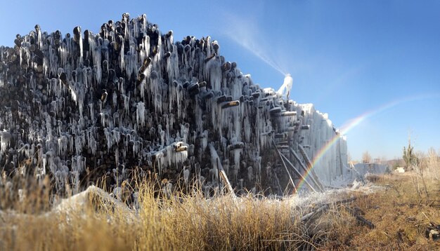 A panoramic view of an open-pit crystal mine, showing the extensive environmental damage and displacement of earth. The image is stark and contrasts sharply with the polished crystals typically seen in retail settings. This image highlights the ethical sourcing and sustainability concerns within the Crystal Healing Market Boom: Projected to Reach $5 Billion in the US by 2026 – Is It Sustainable?.