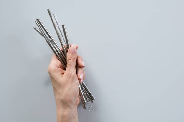 A close-up shot of a person's hands holding L-shaped metal dowsing rods. The rods are crossed in front of them, indicating a 