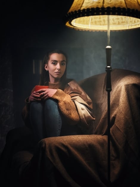 A person sitting in a dimly lit room, gazing intently into a crystal ball placed on a small table. The room is decorated with candles and other mystical objects. The focus is on the crystal ball and the person's focused expression, emphasizing the concentration required for Practical Scrying: A Guide to Crystal Gazing and Divination with Updated Techniques.