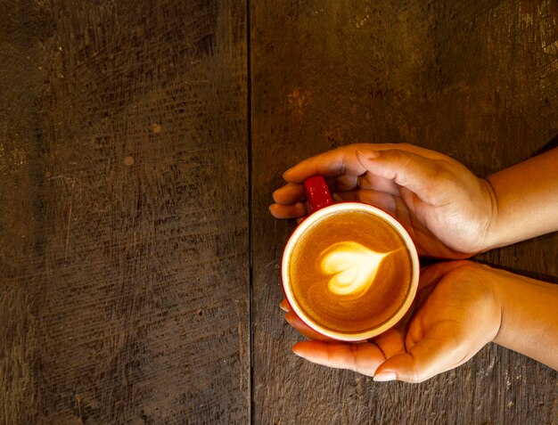 A tranquil image capturing a person's hands gently placing a lit candle on a carefully arranged altar, rich with winter solstice symbols. The soft glow of the candle illuminates other elements such as evergreen branches, crystals, and pinecones, showcasing the essence of How to Prepare Your Altar for the Upcoming 2025 Solstice: A Step-by-Step Guide.