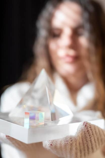 An image of a woman gently holding a small, polished clear quartz crystal near a horse's forehead. The horse appears calm and curious, showing no signs of resistance. The focus is on the gentle introduction of the crystal and the animal's acceptance, highlighting the safe and effective application of Crystal Healing for Pets: Safe and Effective Ways to Support Your Animal's Well-being.