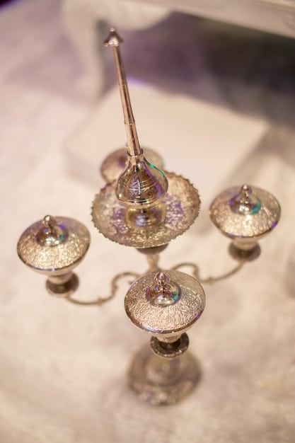 A selection of various crystal pendulums laid out on a velvet cloth, each pendulum made from a different type of crystal (e.g., amethyst, rose quartz, clear quartz). The pendulums vary in shape and size, with some featuring intricate carvings or metal accents. The arrangement is well-lit to showcase the different colors and textures of the crystals, appealing to those seeking The Ultimate Guide to Crystal Pendulums: Ask Questions and Receive Answers.