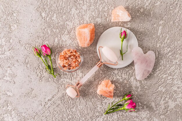 A flat lay arrangement featuring various crystals (Rose Quartz for love, Amethyst for peace, Citrine for abundance) along with small cards displaying corresponding affirmations. The layout is on a light, natural wood surface with soft, diffused lighting to highlight the crystals' colors.